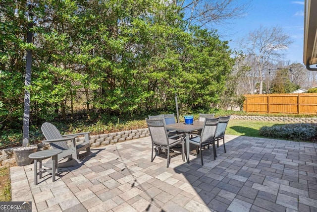 view of patio / terrace featuring outdoor dining area and fence