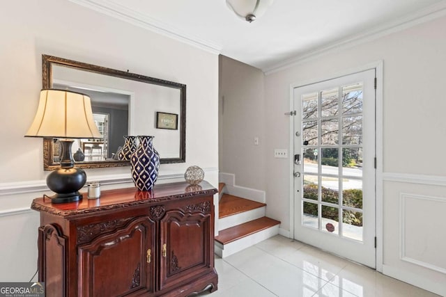 doorway featuring a wealth of natural light, light tile patterned flooring, crown molding, and stairway