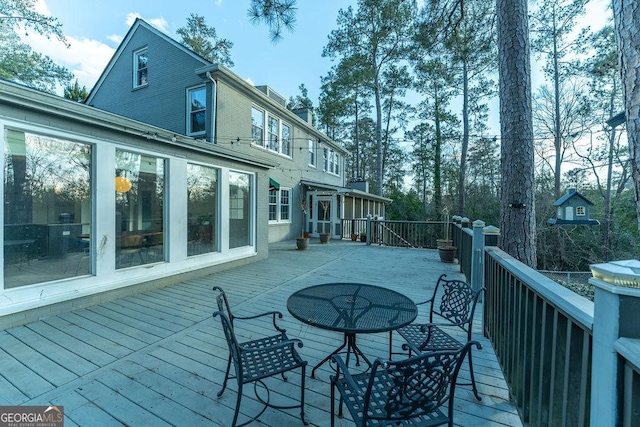 wooden terrace with outdoor dining space