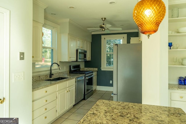 kitchen featuring crown molding, light tile patterned floors, stainless steel appliances, a sink, and light stone countertops