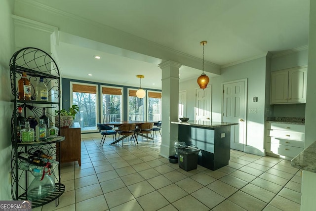 kitchen featuring ornamental molding, pendant lighting, white cabinets, and light tile patterned floors