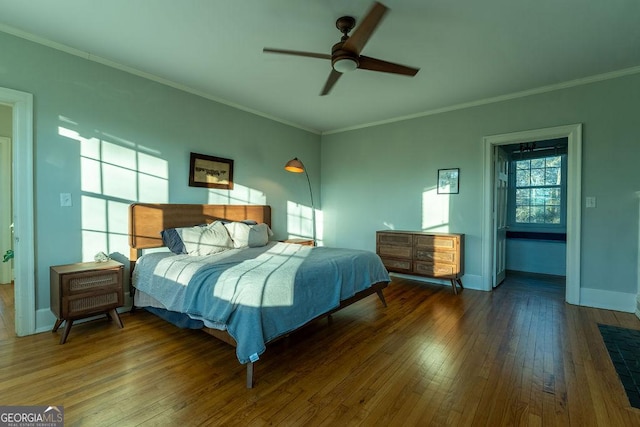 bedroom with baseboards, a ceiling fan, hardwood / wood-style flooring, and crown molding