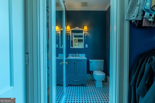 bathroom featuring toilet, visible vents, crown molding, and vanity