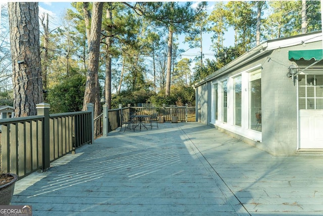 wooden terrace with outdoor dining area