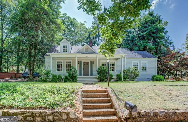 3127 Mill St SE, Covington, GA 30014 - cape cod house featuring a porch, a front yard, crawl space, and a chimney