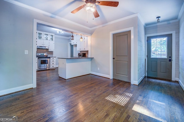 kitchen featuring white cabinets, dark countertops, a peninsula, stainless steel range with electric cooktop, and under cabinet range hood