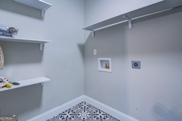 laundry area featuring laundry area, washer hookup, electric dryer hookup, and baseboards