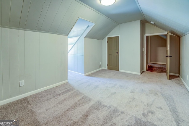 bonus room with carpet floors, lofted ceiling, and baseboards