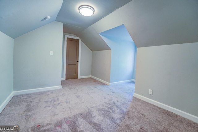 bonus room featuring carpet, baseboards, and vaulted ceiling