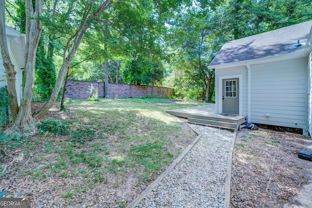 view of yard featuring fence and an outdoor structure