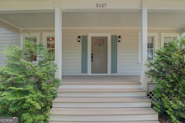 doorway to property featuring covered porch