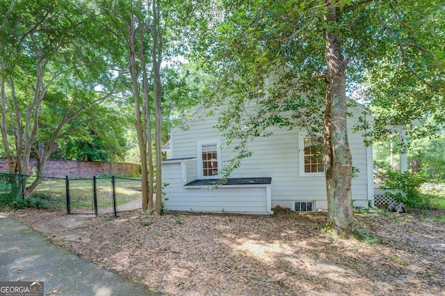 view of property exterior featuring fence