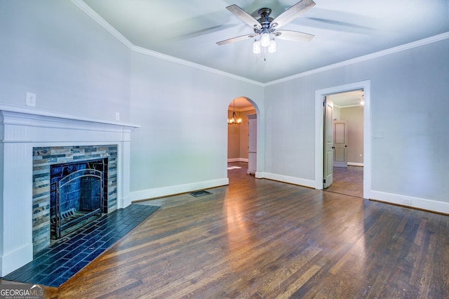 unfurnished living room featuring arched walkways, a tile fireplace, wood finished floors, a ceiling fan, and baseboards