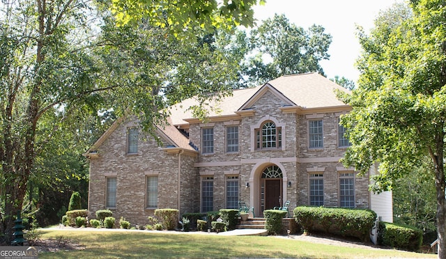 view of front of property with brick siding and a front lawn