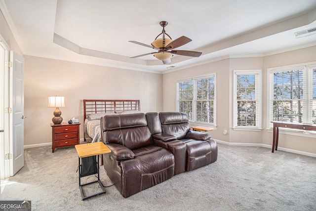 bedroom featuring light carpet, multiple windows, visible vents, and a raised ceiling