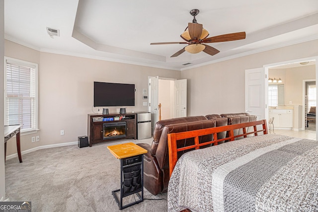 bedroom with crown molding, a raised ceiling, light colored carpet, visible vents, and baseboards