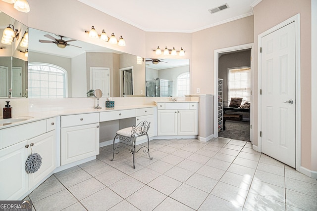 ensuite bathroom with a ceiling fan, tile patterned flooring, visible vents, and crown molding