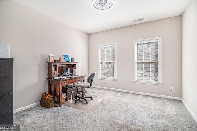 carpeted home office featuring visible vents and baseboards