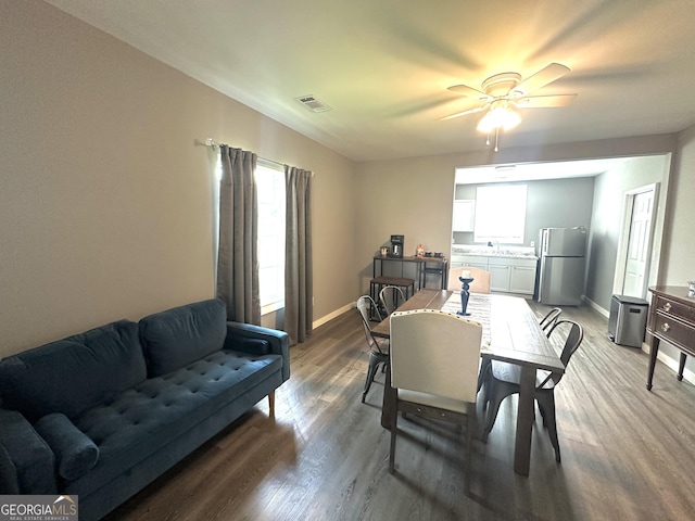dining room featuring a ceiling fan, visible vents, light wood-style flooring, and baseboards