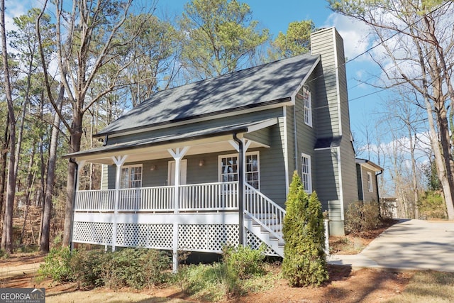 view of front of house with covered porch and a chimney