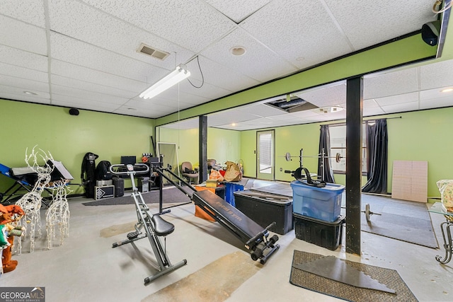 exercise room with visible vents and a drop ceiling