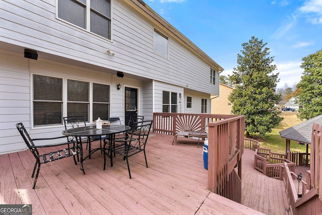 wooden terrace with outdoor dining area