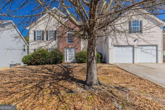 view of front of property with a garage, concrete driveway, and brick siding