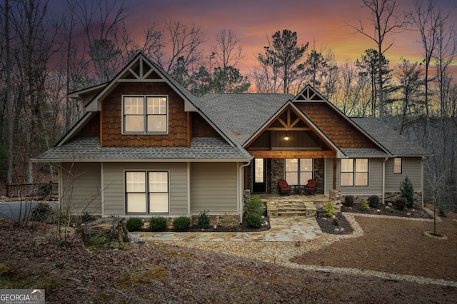 craftsman-style house featuring a patio area and roof with shingles