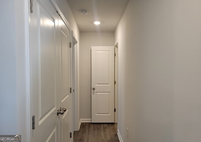 corridor with baseboards and dark wood-style flooring