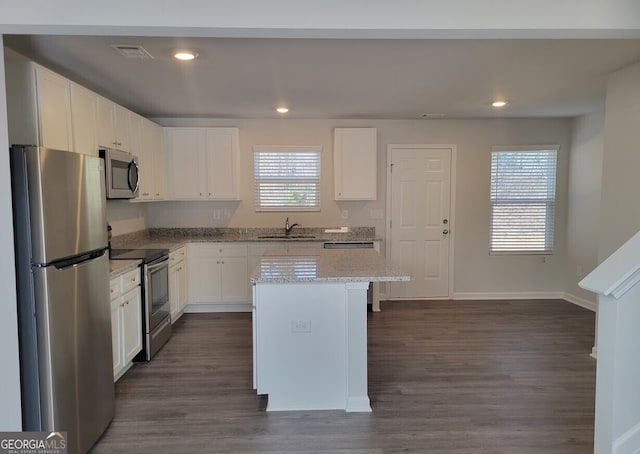 kitchen with visible vents, baseboards, white cabinets, appliances with stainless steel finishes, and dark wood finished floors