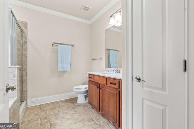 bathroom with toilet, vanity, visible vents, a shower with door, and crown molding