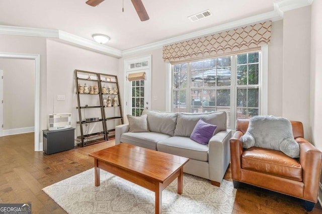 living area featuring visible vents, crown molding, and hardwood / wood-style flooring