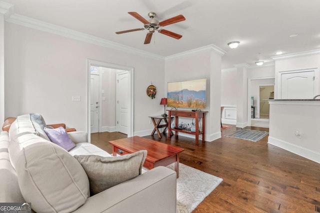 living area featuring ornamental molding, hardwood / wood-style floors, and baseboards