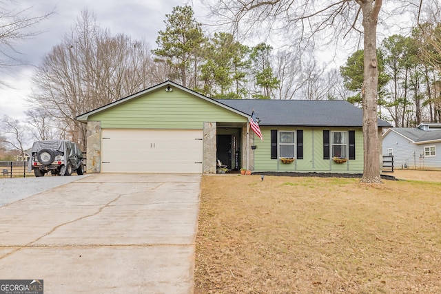 ranch-style house with driveway, an attached garage, and a front yard