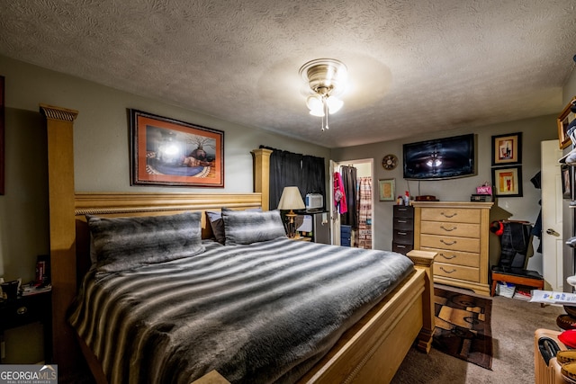 bedroom featuring a closet, carpet, a walk in closet, and a textured ceiling