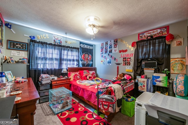 carpeted bedroom featuring cooling unit and a textured ceiling