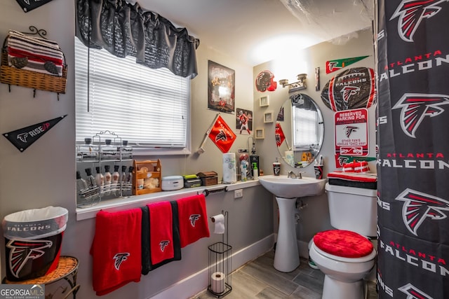 half bathroom featuring toilet and wood finished floors