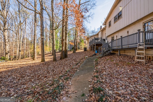 view of yard featuring stairway and a wooden deck