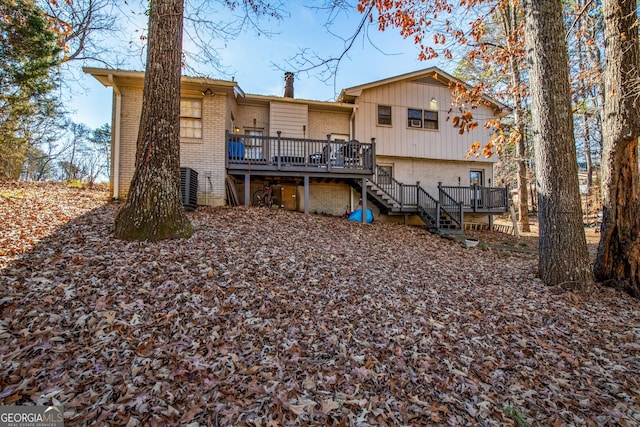 rear view of property with stairway, brick siding, a deck, and central air condition unit