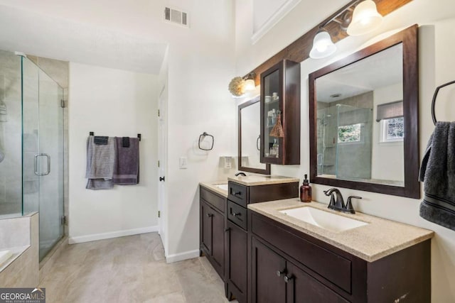 bathroom with visible vents, baseboards, vanity, a shower stall, and a bath