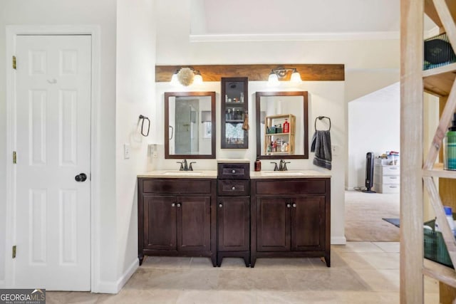 bathroom featuring double vanity, tile patterned flooring, and a sink