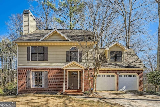 view of front of house featuring driveway, an attached garage, a chimney, and brick siding