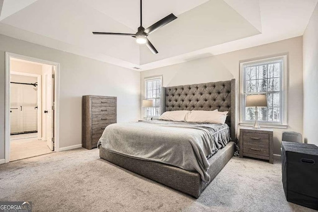 bedroom featuring ensuite bathroom, carpet floors, multiple windows, and baseboards