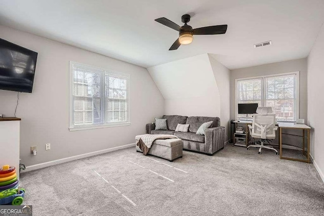 carpeted living room featuring a healthy amount of sunlight, visible vents, and baseboards