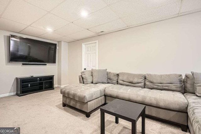 living area with light carpet, baseboards, and a drop ceiling