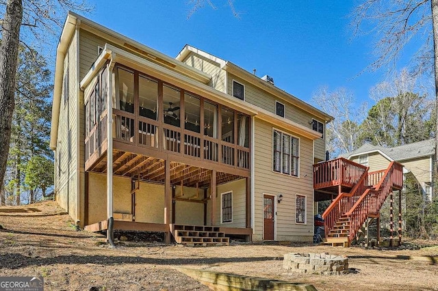 back of house with a deck, stairway, and a sunroom