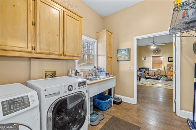 laundry room with ceiling fan, washing machine and clothes dryer, baseboards, cabinet space, and dark wood finished floors