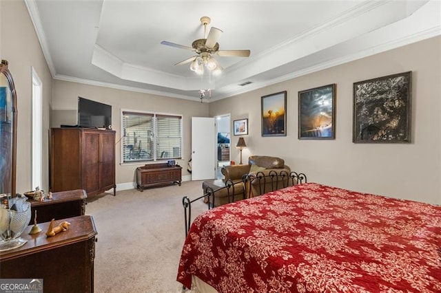 bedroom featuring a raised ceiling, ornamental molding, carpet flooring, ceiling fan, and baseboards