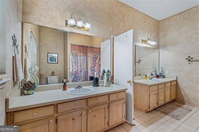 full bath featuring tile patterned flooring, two vanities, and a sink