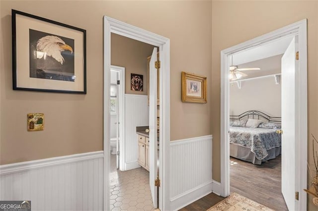 hallway with wainscoting and wood finished floors